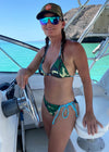 Woman on a fishing boat wearing a camo and turquoise string bikini and a camo hat from River to Ridge Clothing Brand