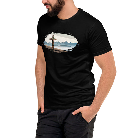 Person wearing a black t-shirt with a cross and mountain design on a white background