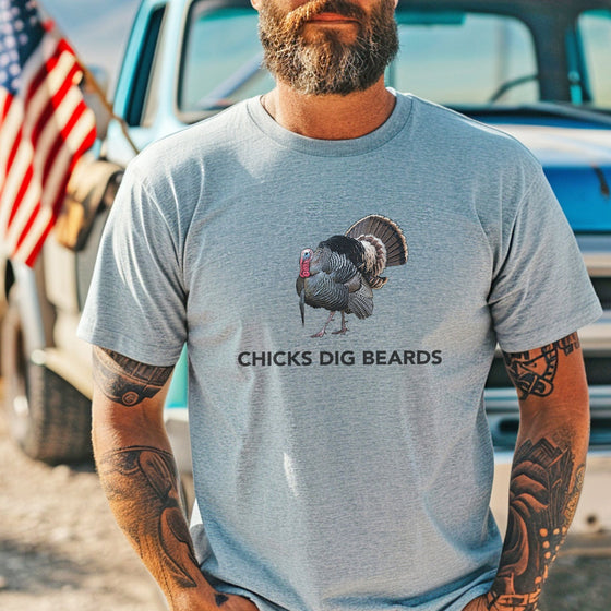 Man wearing a t-shirt with a graphic of a turkey and text, standing in front of a truck.