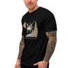 Man wearing a black t-shirt with a graphic design of an elk and mountains, with tattoos on his arms. from River to Ridge Clothing