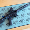 Rifle on a blue mat with deer patterns