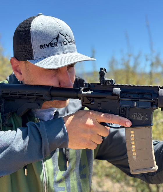 Man wearing a grey and black River to Ridge Logo Hat and a Tactical USA hoodie