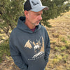 Man wearing a hoodie with nature-themed design outdoors