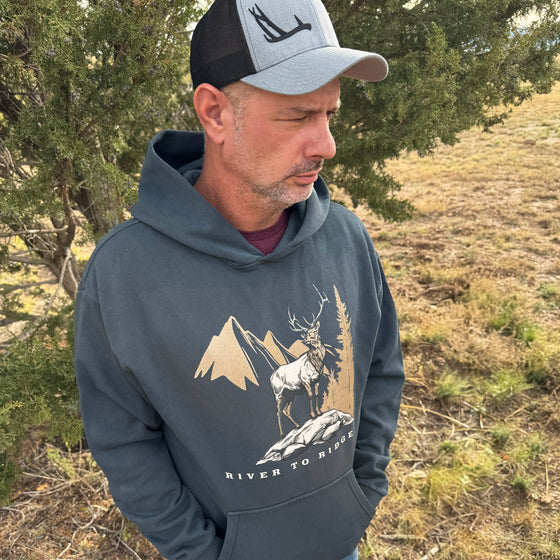 Man wearing a hoodie with nature-themed design outdoors