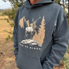 Person wearing a hoodie with a nature-themed graphic and text 'Never to Ridge'.