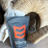 MTN OPS Hydrate supplement package on a textured surface with a skull in the background