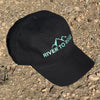Black cap with 'River to Ridge' logo on a gravel surface