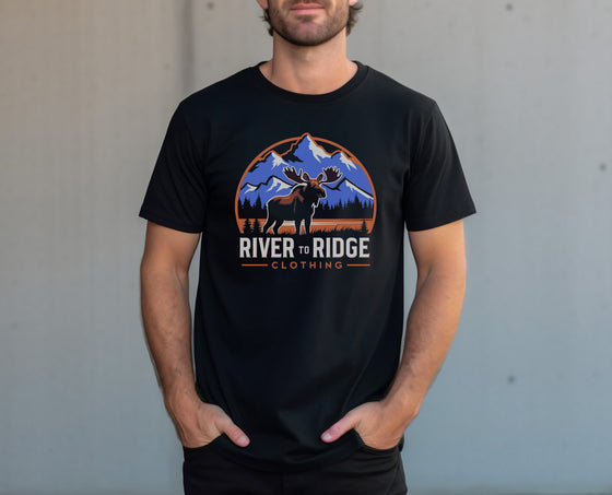 Person wearing a black t-shirt with a moose graphic and 'River to Ridge Clothing' text.