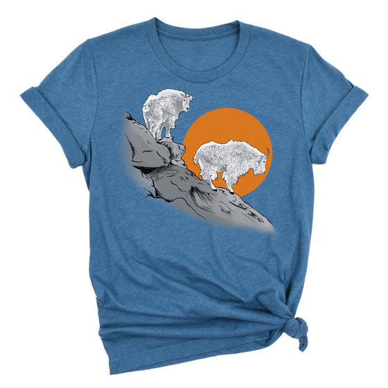 Blue t-shirt with a graphic of two mountain goats on a rock and an orange sun in the background