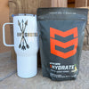 White tumbler with 'Bowhunted' design and MTN OPS Hydrate supplement package on a surface.