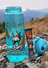 Blue water bottle with mountain and elk design from River to Ridge Brand, supplement tube from Mtn Ops and a rocky surface with a mountainous background.