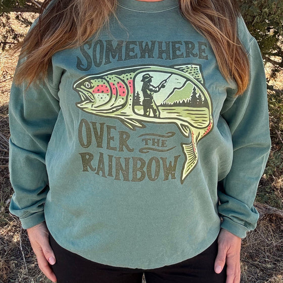 Product mockup of a River to Ridge Clothing Brand Somewhere Over the Rainbow Womens Trout fishing Pullover sweatshirt with a woman fishing inside a rainbow trout drawing.