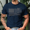 Man wearing a navy blue t-shirt with a graphic design, standing outdoors.