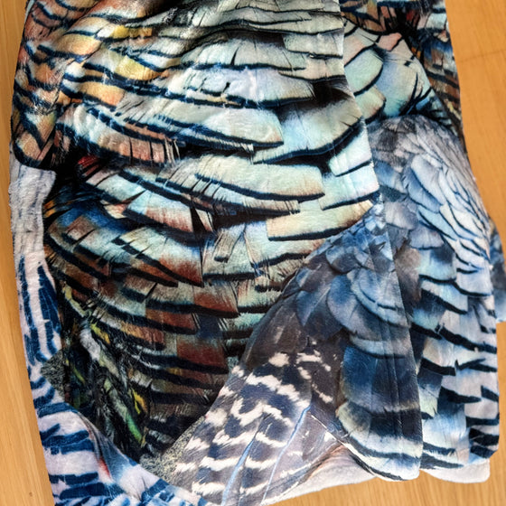 Turkey Feather Pattern Throw Blanket from River to Ridge Brand, on the couch