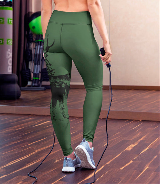 Person wearing green leggings holding a jump rope in a gym setting