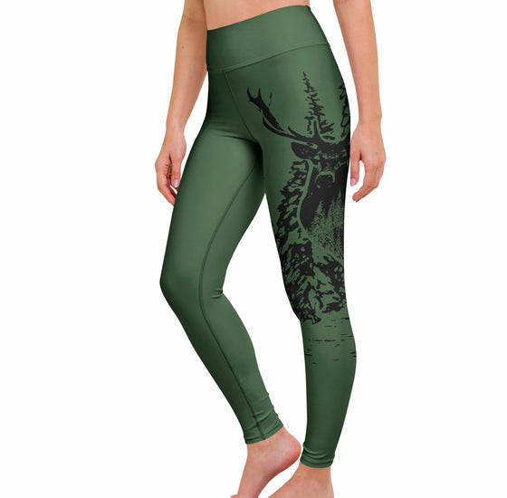 Green leggings with deer design worn by a person on a white background