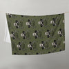 Green fabric with skull and crossbones pattern on a white background