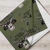 Green fabric with deer head designs and text on a wooden surface