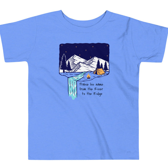 Product mockup of a Christian Scripture T shirt from River To Ridge clothing for children with a waterfall and camping tent on it