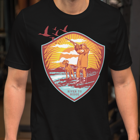 Product mockup of a waterfowl hunting t shirt of goose hunt with a man and dog on a guy at the gym in black