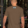 Man wearing a brown t-shirt with a logo on the back in a gym setting