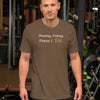 Man wearing a brown t-shirt with text in a gym setting