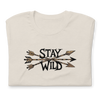 Product mockup of a River to Ridge Clothing Brand T Shirt for Women with the Stay Wild Archery Bowhunting Logo on it with traditional african arrows