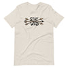 Product mockup of a River to Ridge Clothing Brand T Shirt for Women with the Stay Wild Archery Bowhunting Logo on it with traditional african arrows