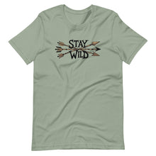  Product mockup of a River to Ridge Clothing Brand T Shirt for Women with the Stay Wild Archery Bowhunting Logo on it with traditional african arrows