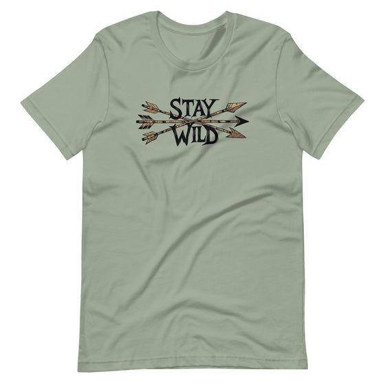 Product mockup of a River to Ridge Clothing Brand T Shirt for Women with the Stay Wild Archery Bowhunting Logo on it with traditional african arrows
