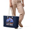 Person holding a navy tote bag with 'River to Ridge Clothing' logo on a white background