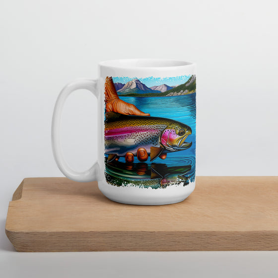 Product mockup of a River to Ridge Clothing Brand Trout Fishing large coffee mug with a rainbow trout being held above the river in bright colors