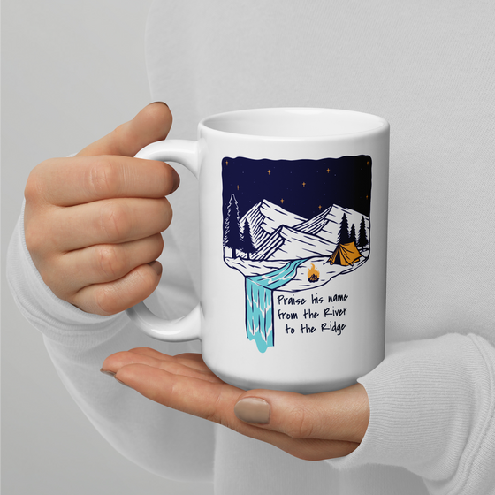 Product mockup of a Christian Outdoor Lifestyle Coffee Mug from River to Ridge Clothing Brand with a mountain scene and tent and uplifting words.