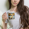Woman holding a mug with a dog design against a plain background