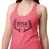 Woman wearing a pink tank top with 'River to Ridge' design on a white background