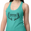 Woman wearing a teal tank top with 'River to Ridge' design on a white background